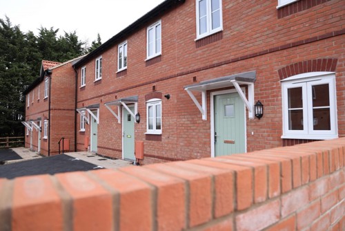 Row of houses at Brockhampton lane development, there is also a brick wall in front with hedges