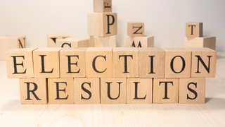 Wooden blocks spelling out the words 'election results'